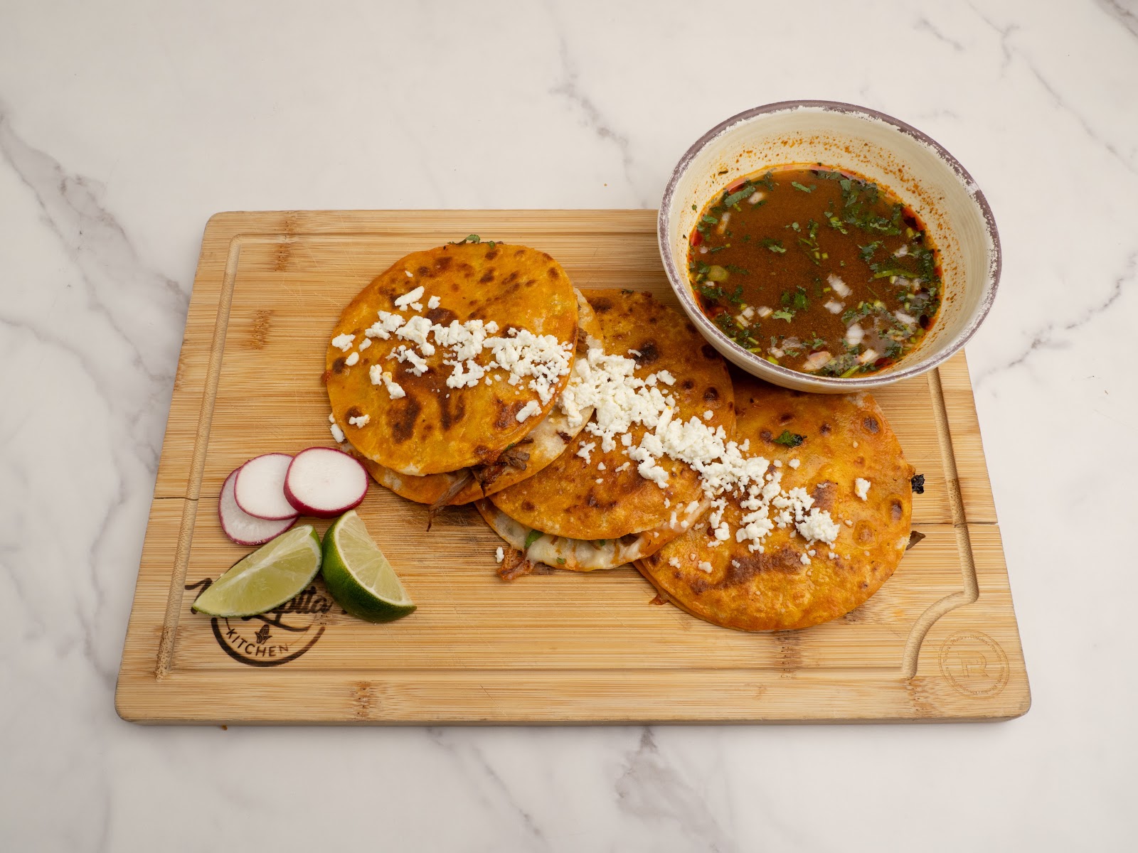 Mulitas — pressed corn tortilla sandwiches with melted cheese and meats