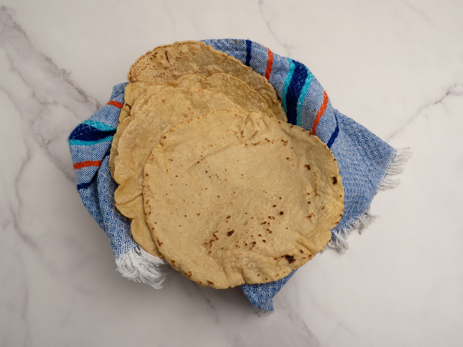 Handmade nixtamalized tortillas pressed fresh every day